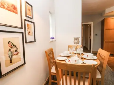 a dining room with a table and chairs at Bella Vita in Southport