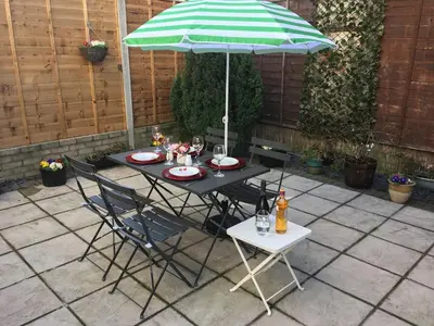 a table and chairs under an umbrella on a patio at Bella Vita in Southport