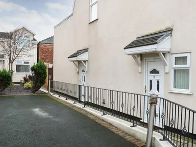 a house with a black fence and a driveway at Bella Vita in Southport