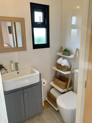 a bathroom with a sink and a toilet and a mirror at Ribble Valley Retreat in Langho