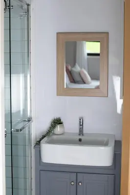 a bathroom sink with a mirror and a shower at Ribble Valley Retreat in Langho