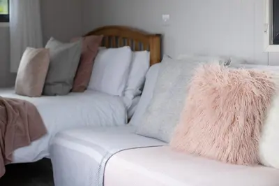 a living room with a couch and a chair with pillows at Ribble Valley Retreat in Langho