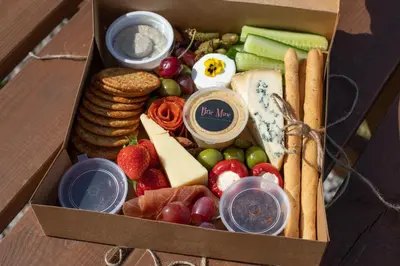 a box filled with different types of cheese and vegetables at Ribble Valley Retreat in Langho