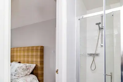 a bathroom with a shower with a glass door at Mill Charm in Barrow in Furness