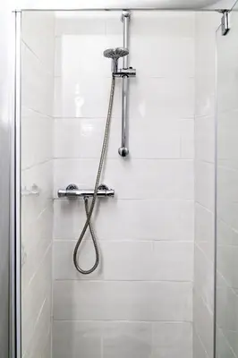 a shower with a hose in a bathroom at Mill Charm in Barrow in Furness