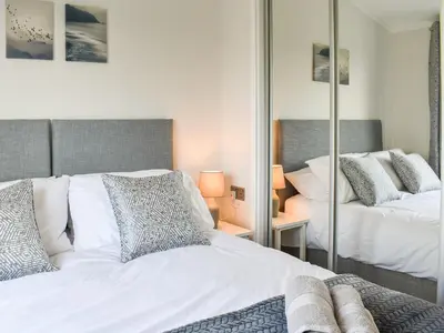 a bedroom with two beds and a mirror at The View - Uk36812 in Whalley
