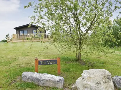 a sign in the grass in front of a house at The View - Uk36812 in Whalley