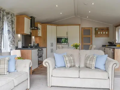 a living room with two couches and a kitchen at Lake View - Uk36811 in Whalley