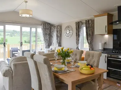 a kitchen and living room with a table and chairs at Lake View - Uk36811 in Whalley