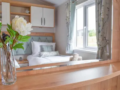 a mirror in a room with a bed at Lake View - Uk36811 in Whalley