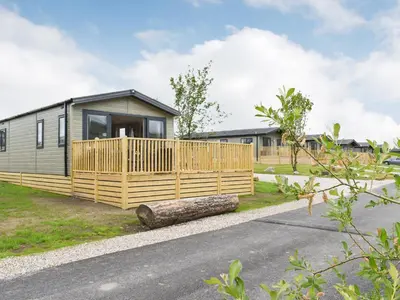 a tiny house with a large wooden deck at Lake View - Uk36811 in Whalley