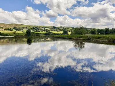 a reflection of the sky in a pond of water at Lake View - Uk36811 in Whalley