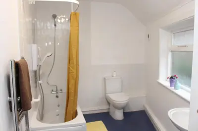 a bathroom with a shower and a toilet at Morning Star Home in Liverpool
