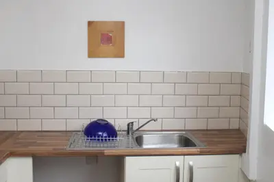 a kitchen sink with a blue tea kettle on it at Morning Star Home in Liverpool