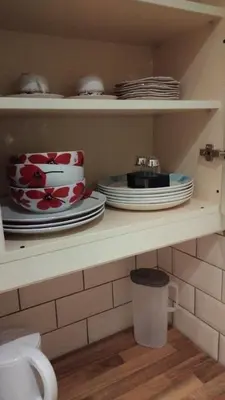 a shelf with plates and dishes on it at Morning Star Home in Liverpool