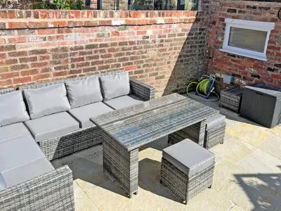 a picnic table and a bench and a brick wall at Sandend in Lytham St Annes