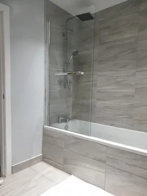 a bathroom with a shower and a bath tub at Stunning 5 bed house, 2 mins to beach and town, with free parking in Blackpool
