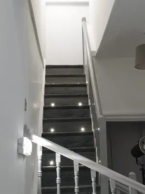 a staircase in a house with lights on the stairs at Stunning 5 bed house, 2 mins to beach and town, with free parking in Blackpool