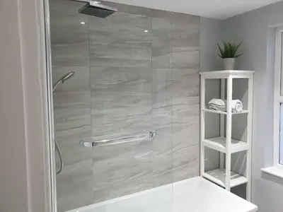 a bathroom with a shower with a glass door at Stunning 5 bed house, 2 mins to beach and town, with free parking in Blackpool