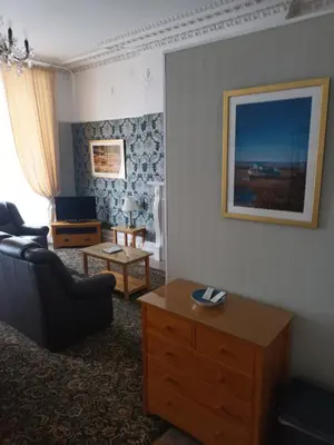 a living room with a couch and a table at Eden Vale Ground Floor Sea View Apartment in Morecambe