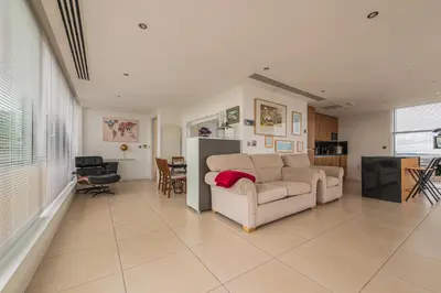 a living room with a couch and a table at Sidemersey Livings- Unmatched Panoramic Views, Secure Parking, Beautiful Balcony- A Stay to Remember in Liverpool