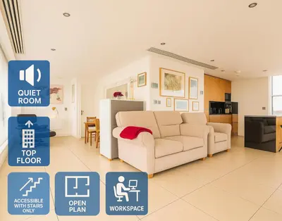 a living room with a couch and a kitchen at Sidemersey Livings- Unmatched Panoramic Views, Secure Parking, Beautiful Balcony- A Stay to Remember in Liverpool