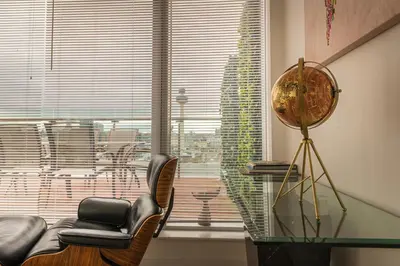 a room with chairs and a glass table and a window at Sidemersey Livings- Unmatched Panoramic Views, Secure Parking, Beautiful Balcony- A Stay to Remember in Liverpool