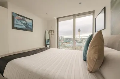 a bedroom with a large bed and a large window at Sidemersey Livings- Unmatched Panoramic Views, Secure Parking, Beautiful Balcony- A Stay to Remember in Liverpool
