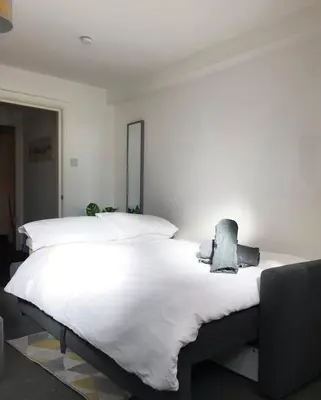 a bedroom with a large white bed in it at FLATZY - Modern Apartment Close to Football Stadiums in Liverpool
