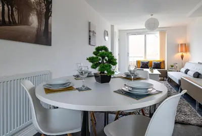 a white dining room with a white table and chairs at Stanley Sparkle Stays - 4BRooms, 4Beds, Prkg, Wifi in Liverpool