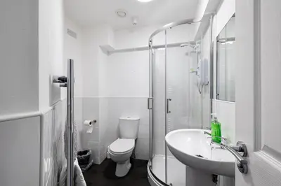a white bathroom with a toilet and a sink at Stanley Sparkle Stays - 4BRooms, 4Beds, Prkg, Wifi in Liverpool