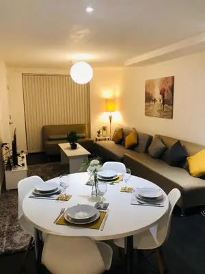a living room with a white table and a couch at Stanley Sparkle Stays - 4BRooms, 4Beds, Prkg, Wifi in Liverpool