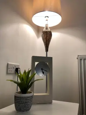 a lamp on a table with a plant and a mirror at Stanley Sparkle Stays - 4BRooms, 4Beds, Prkg, Wifi in Liverpool