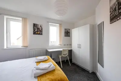 a bedroom with a bed and a desk in it at Stanley Sparkle Stays - 4BRooms, 4Beds, Prkg, Wifi in Liverpool