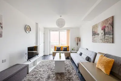 a living room with a couch and a tv at Stanley Sparkle Stays - 4BRooms, 4Beds, Prkg, Wifi in Liverpool