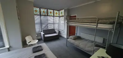 a small room with bunk beds and a chair at Blackpool North Close to Station - With Free Car Parking in Blackpool
