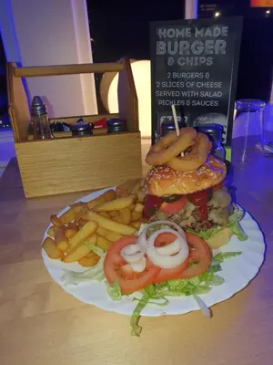 a plate of food with a hamburger and french fries at Blackpool North Close to Station - With Free Car Parking in Blackpool