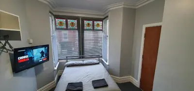 a bedroom with a bed and a flat screen tv at Blackpool North Close to Station - With Free Car Parking in Blackpool