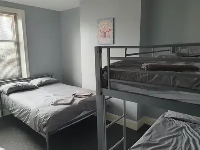 a bedroom with two bunk beds and a window at Blackpool North Close to Station - With Free Car Parking in Blackpool