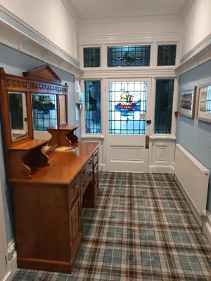 a bathroom with a vanity and stained glass windows at Eden Vale Garden View Apartment with Patio in Morecambe