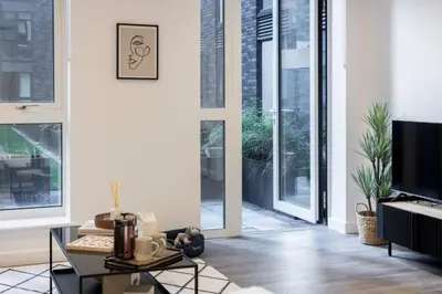 a living room with large windows and a tv at Copper House in Liverpool in Liverpool