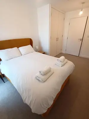 a bedroom with a large white bed with towels on it at Copper House in Liverpool in Liverpool