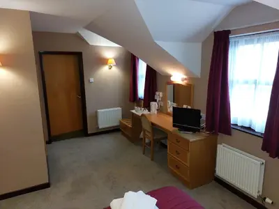 a room with a desk with a computer in it at The County Lodge in Carnforth