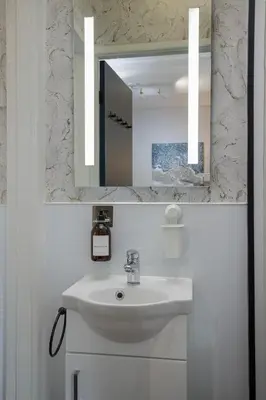 a bathroom with a sink and a mirror at Lunar Stays in Blackpool
