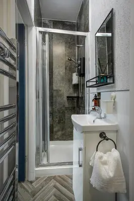 a bathroom with a shower and a sink and a toilet at Lunar Stays in Blackpool