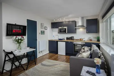 a kitchen and living room with a couch and a table at Lunar Stays in Blackpool