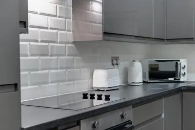 a kitchen with a counter top with a microwave at Harrisons Aparthotel Liverpool in Liverpool