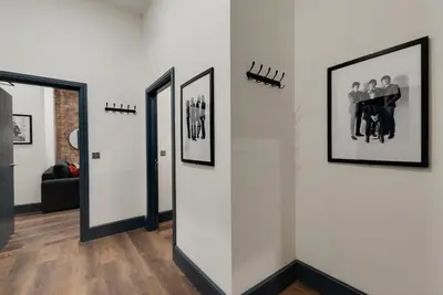 a hallway with three framed pictures on a wall at Harrisons Aparthotel Liverpool in Liverpool
