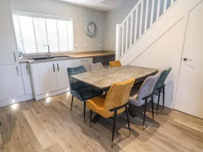 a kitchen and dining room with a table and chairs at White Stones in Ulverston