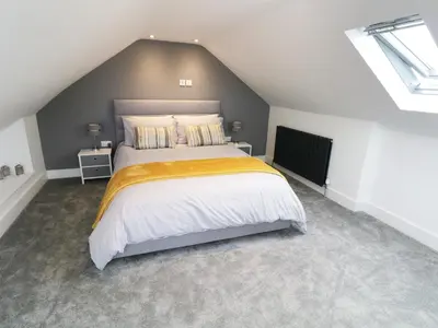 a bedroom with a large bed in a attic at White Stones in Ulverston